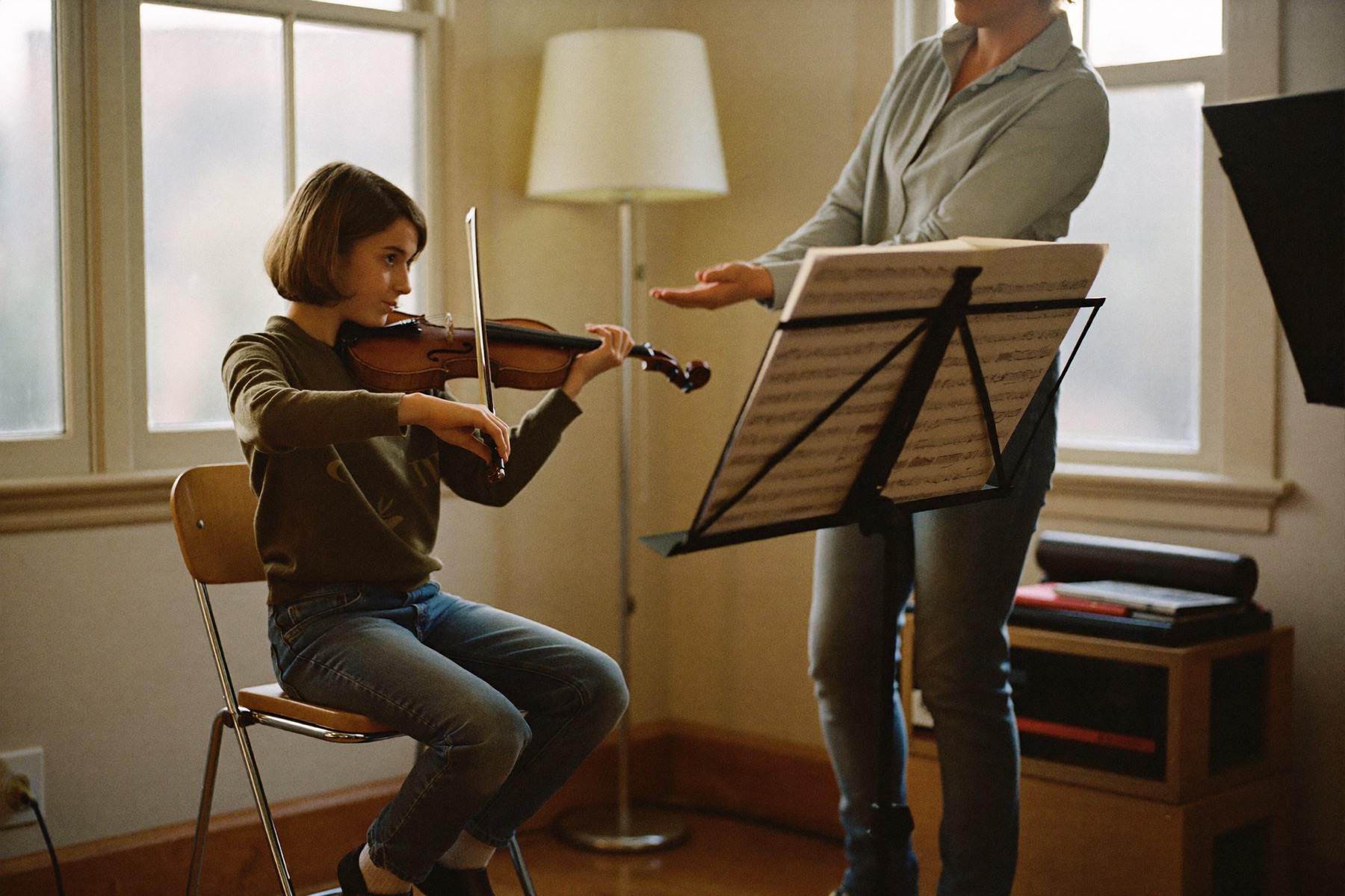 Violin student working on bow technique with a teacher during a lesson at Musical Moments